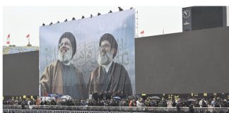 *الأعلام اللبنانيّة تلفّ سور المدينة الرياضيّة الخارجيّ قبيل تشييع’ نصرالله’*